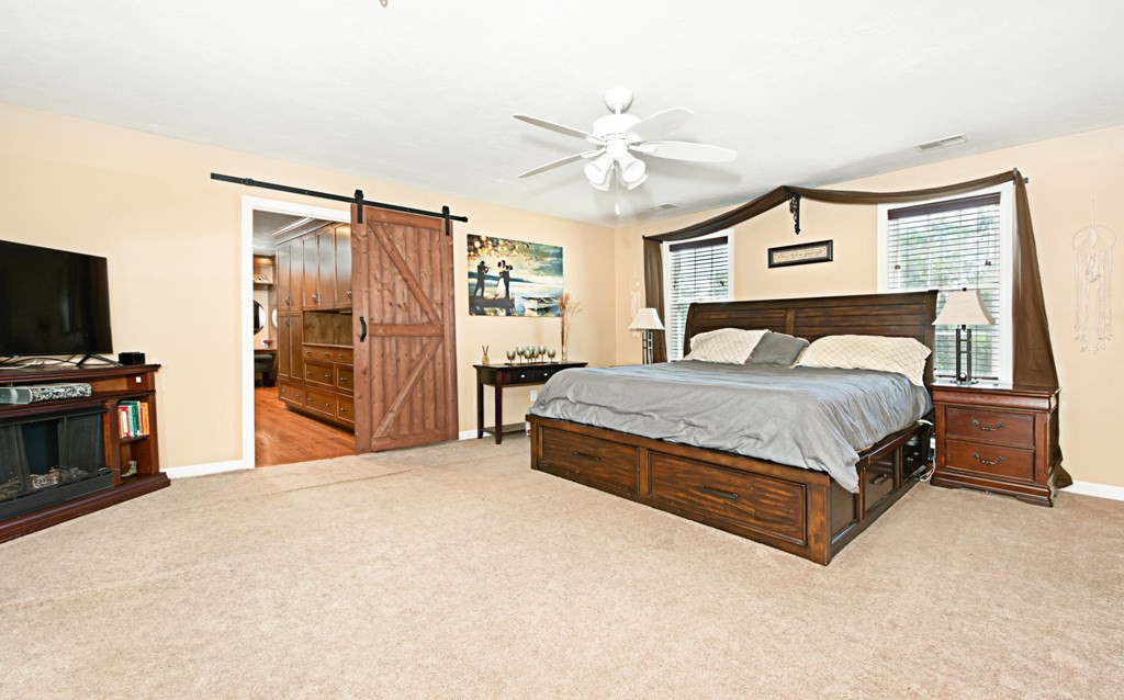 137 Osgood Road Charlton, MA 01507 - Photo 36 of 41 a spacious bedroom with a bed and a flat screen tv