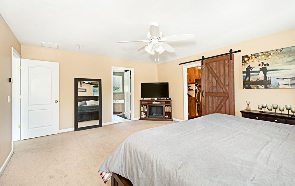 137 Osgood Road Charlton, MA 01507 - Photo 37 of 41 a bedroom with a bed and a flat screen tv