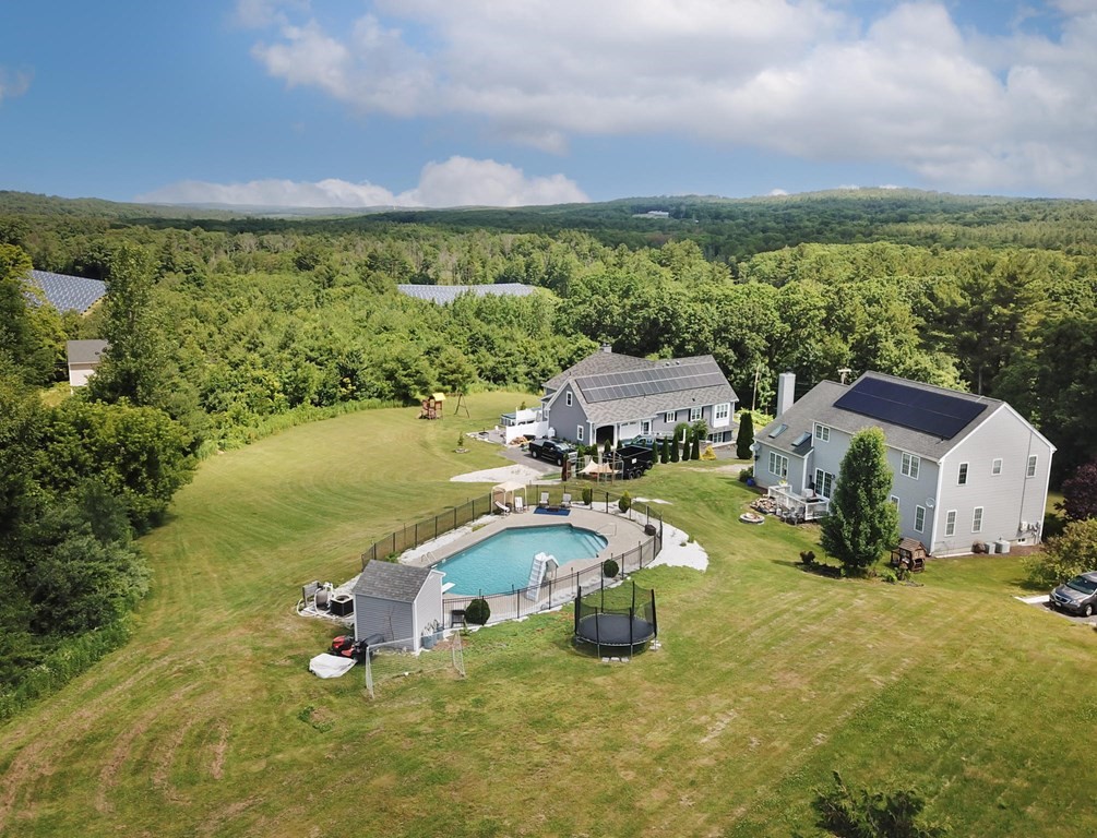 137 Osgood Road Charlton, MA 01507 - Photo 4 of 41 an aerial view of a house with outdoor space and a lake view in back