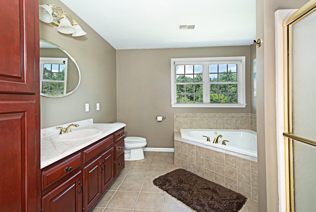 137 Osgood Road Charlton, MA 01507 - Photo 41 of 41 a bathroom with a sink a toilet and a mirror