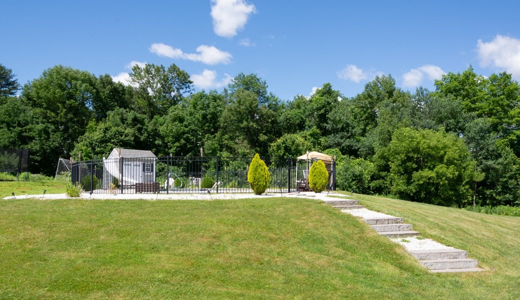 137 Osgood Road Charlton, MA 01507 - Photo 7 of 41 a garden with trees in the background