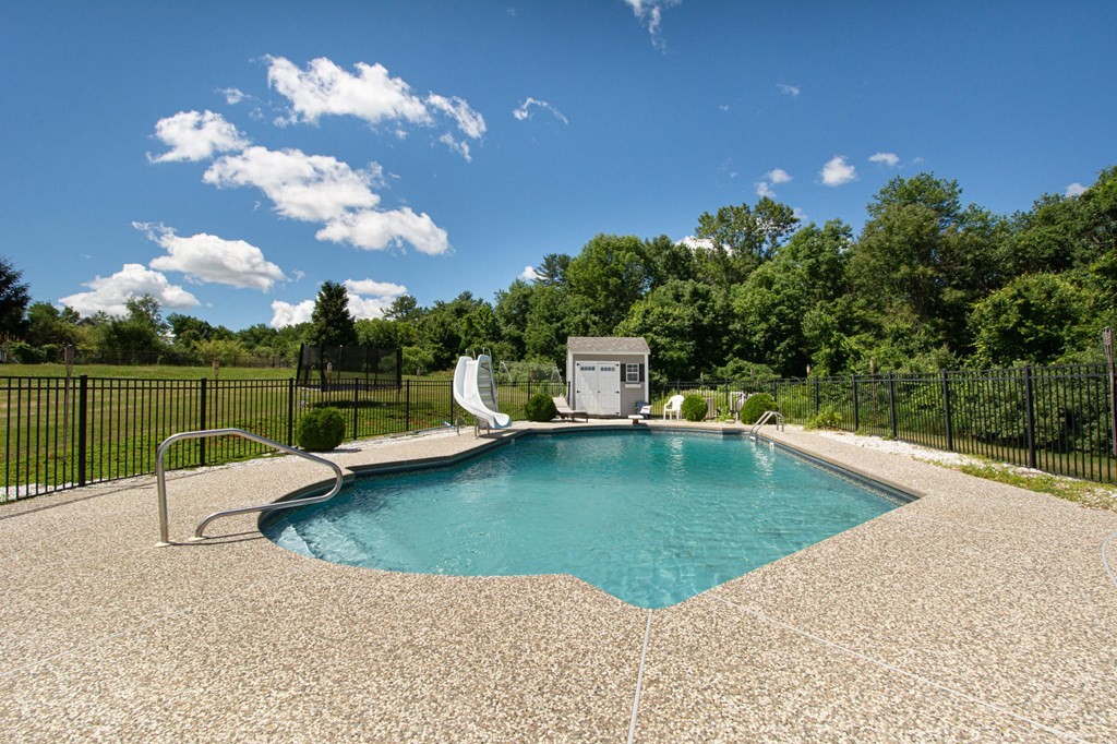 137 Osgood Road Charlton, MA 01507 - Photo 9 of 41 a view of a swimming pool with a lounge chairs