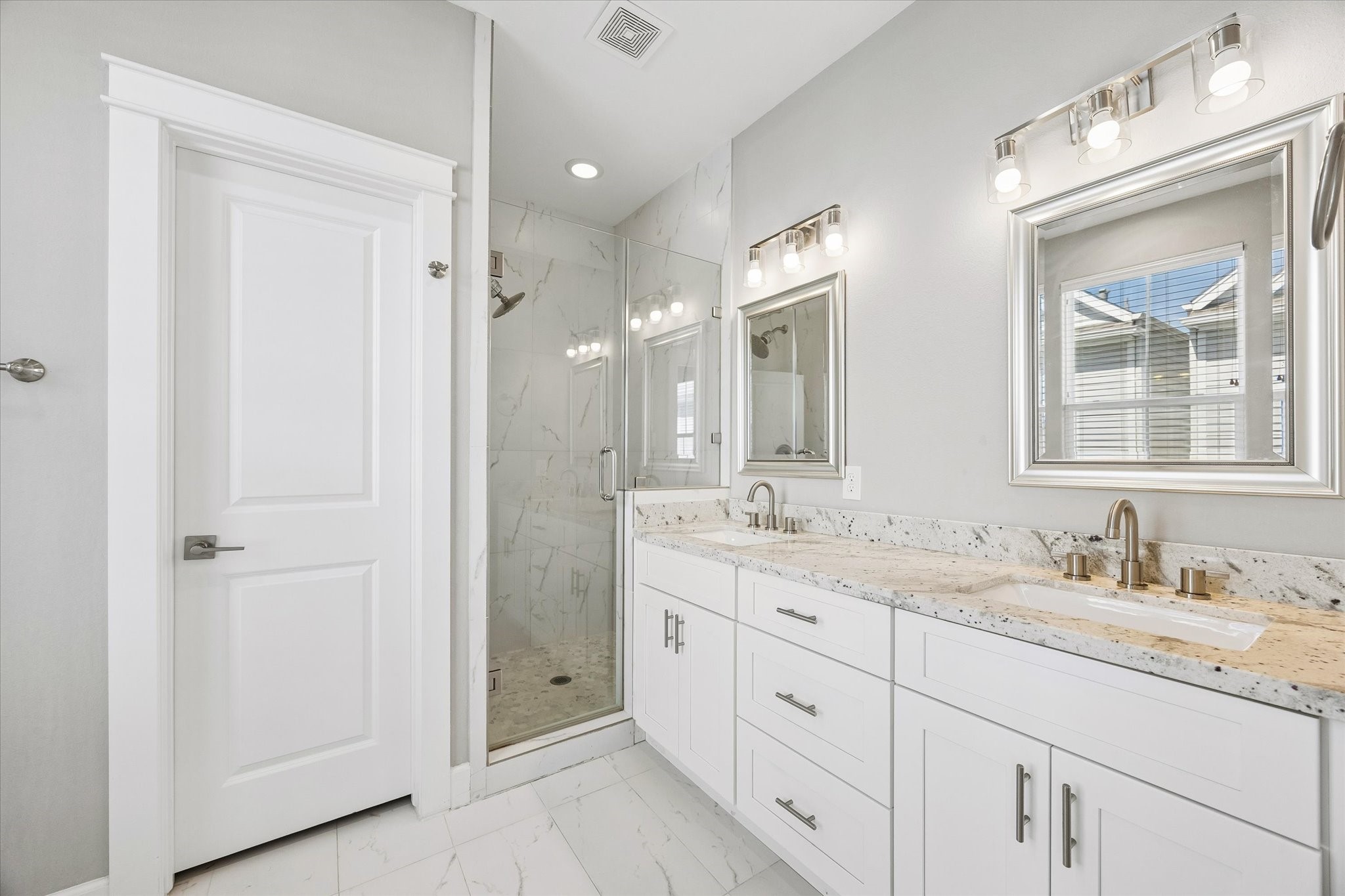 603 Link Road, Unit F Houston, TX 77009 - Photo 16 of 37 Primary bath features an oversized walk-in shower, dual sinks and generous counter space. Clean finishes and abundant storage create a bright, polished space for everyday routines.
