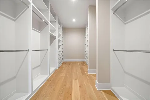 an empty room with window and wooden floor