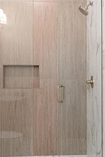 an empty room with wooden floor cabinet and windows