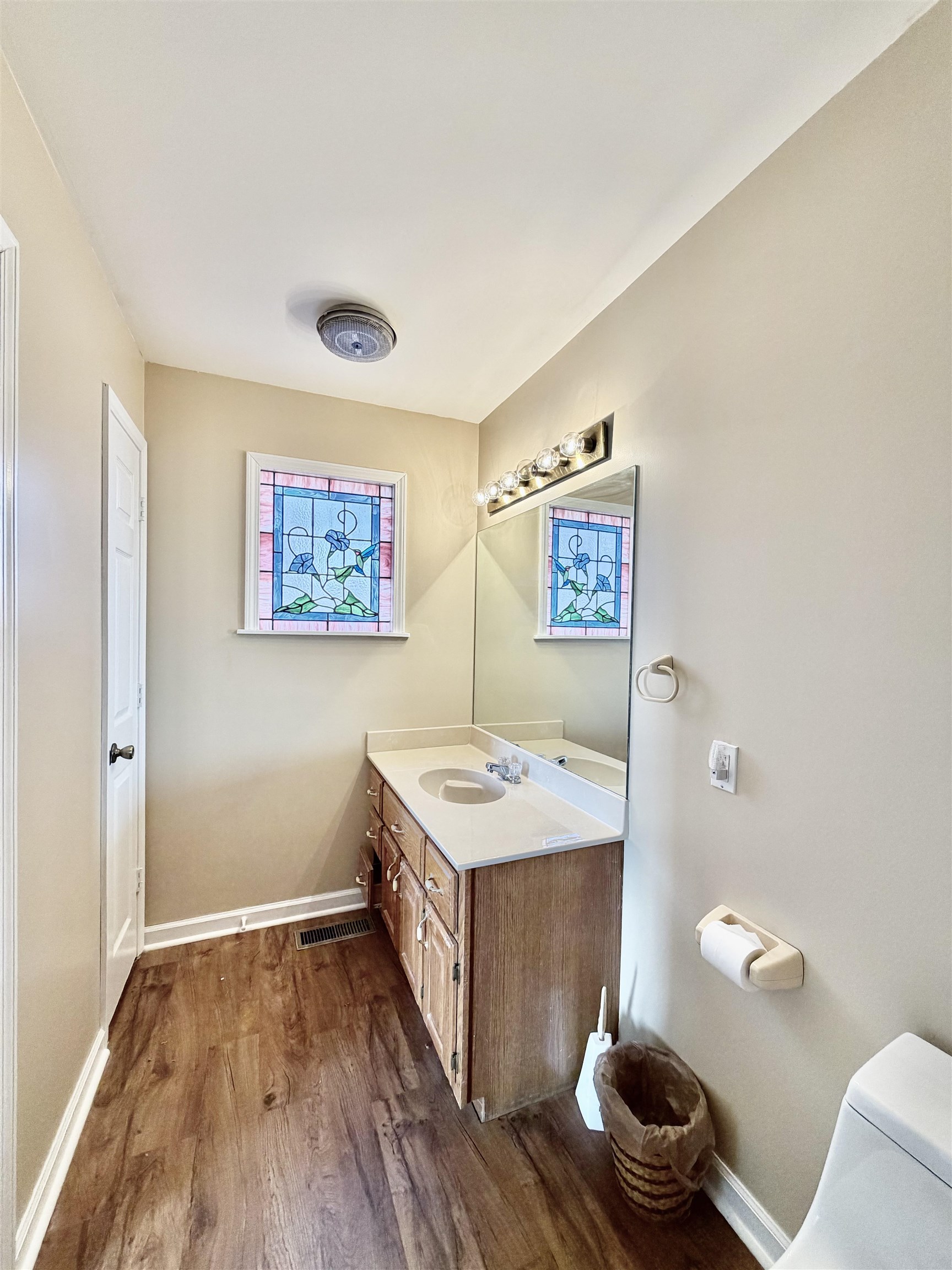 1086 Sloan Road Burlison, TN 38015 - Photo 16 of 24 Bathroom featuring vanity and dark wood-style floors