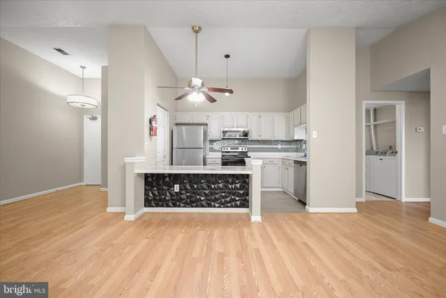 a view of kitchen with sink microwave and refrigerator