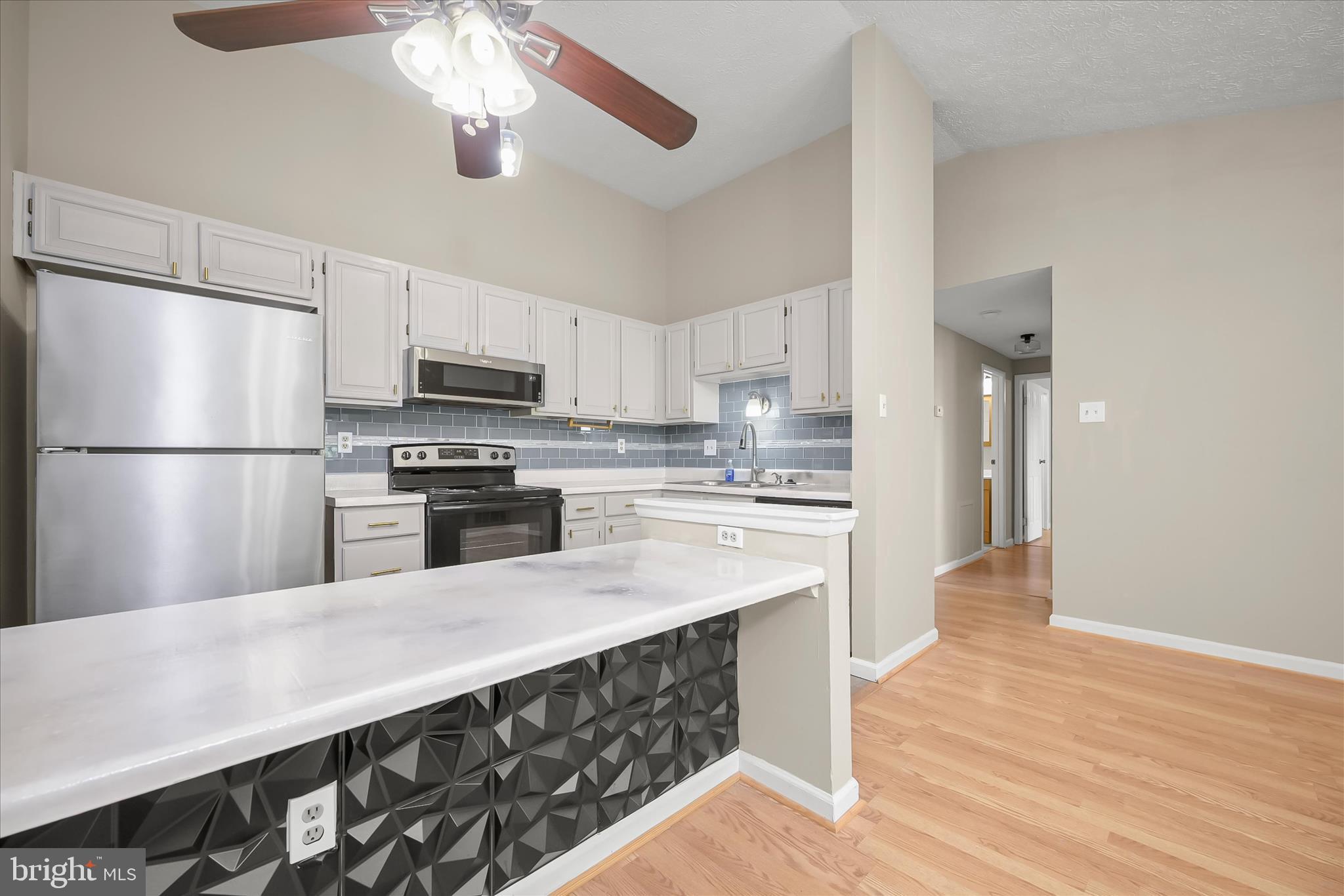 12309 Silvergate Way, Unit 908K Germantown, MD 20874 - Photo 9 of 37 a kitchen with stainless steel appliances a refrigerator a stove sink and white cabinets