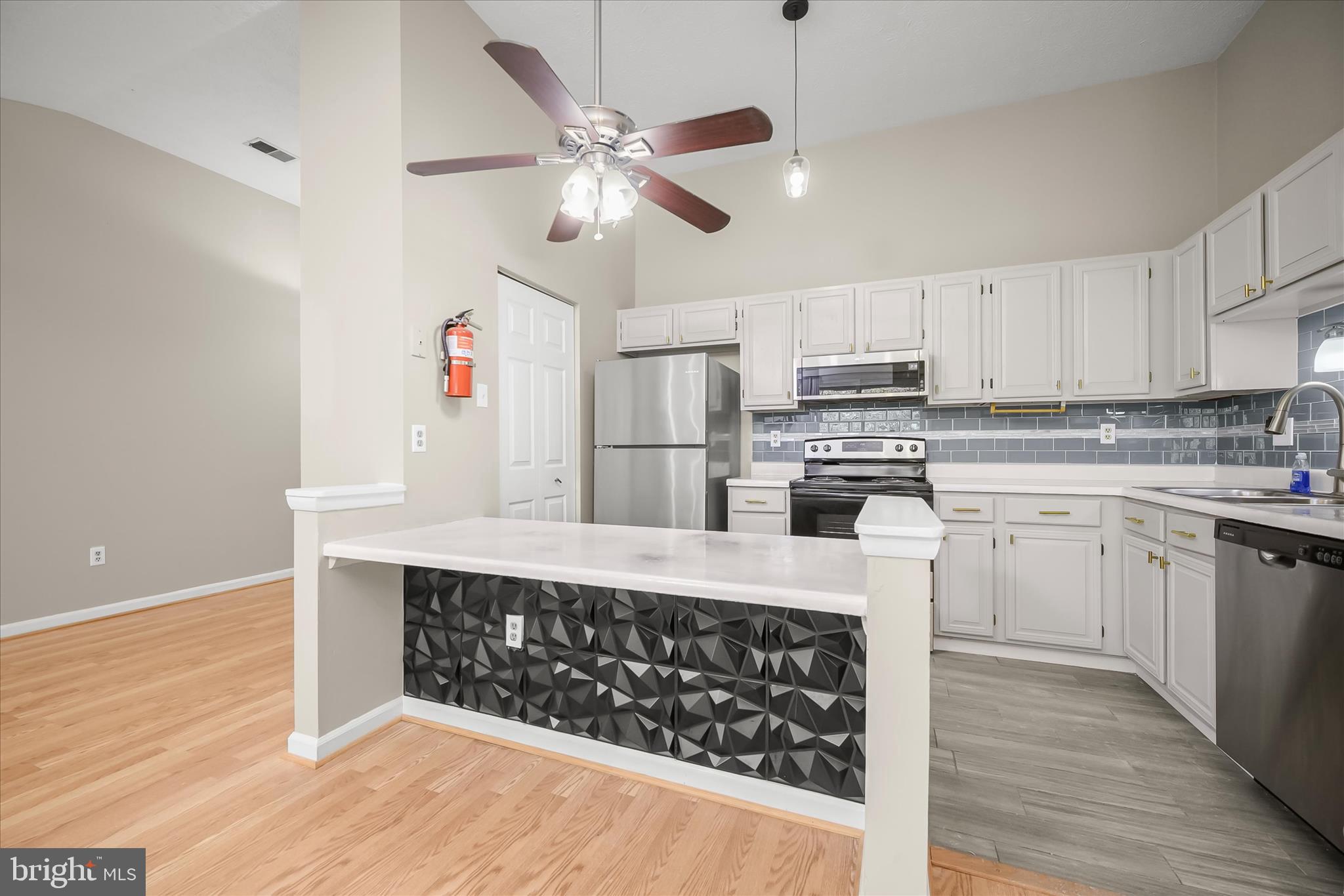 12309 Silvergate Way, Unit 908K Germantown, MD 20874 - Photo 10 of 37 a kitchen with stainless steel appliances a stove a sink and cabinets