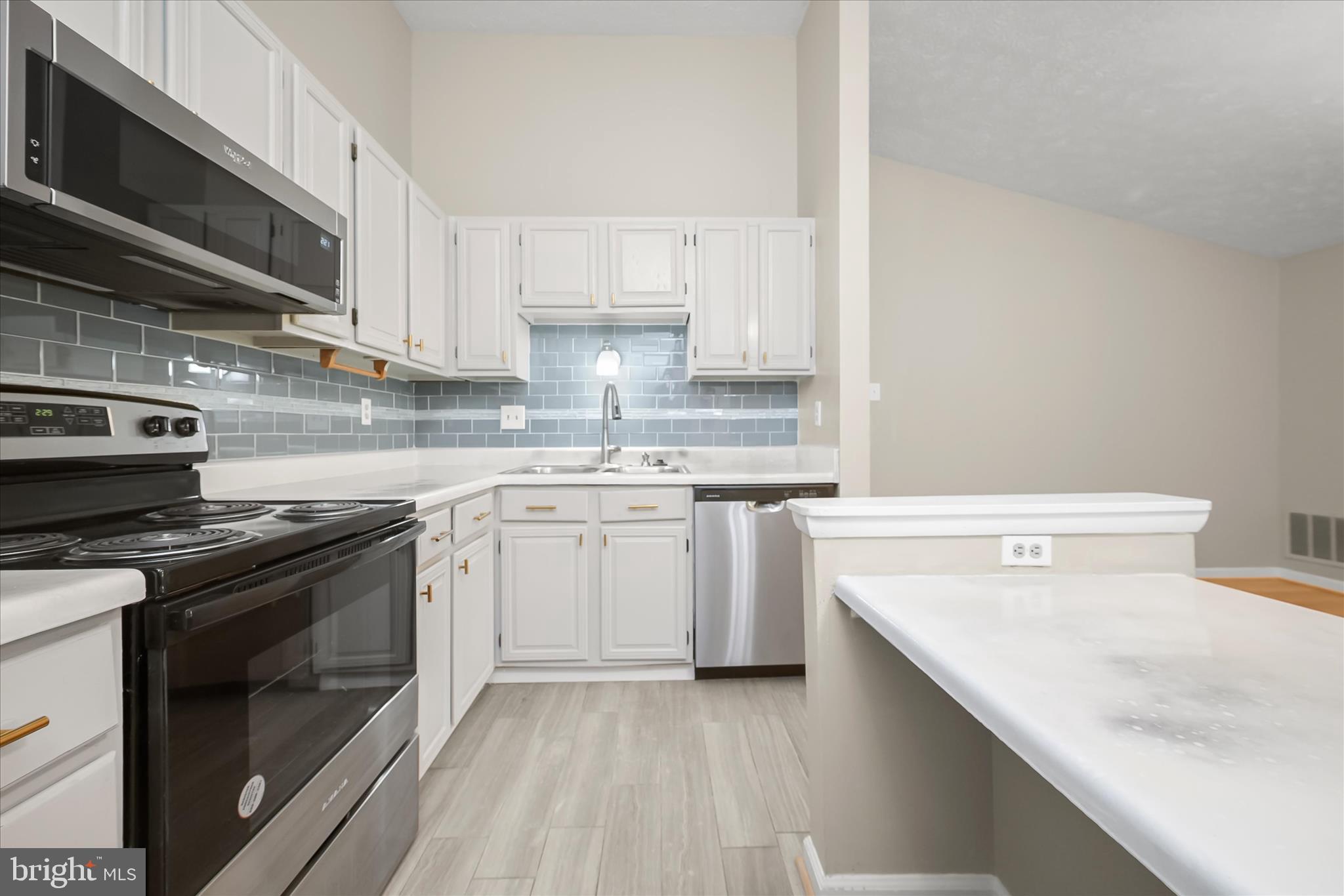 12309 Silvergate Way, Unit 908K Germantown, MD 20874 - Photo 14 of 37 a kitchen with a sink stove top oven and cabinets