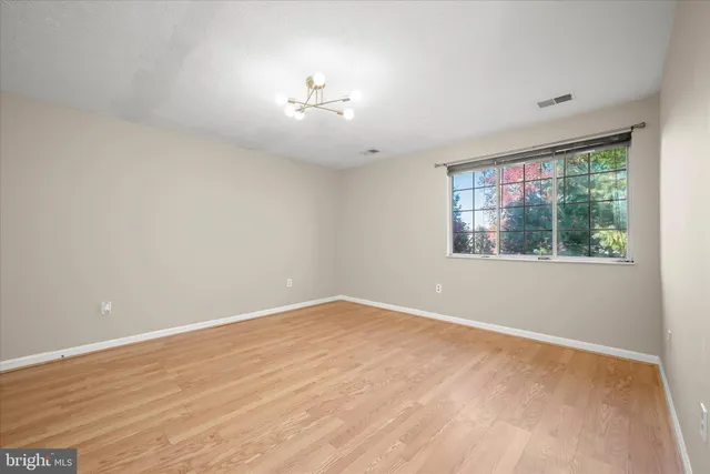 a kitchen with stainless steel appliances granite countertop white cabinets and a stove top oven