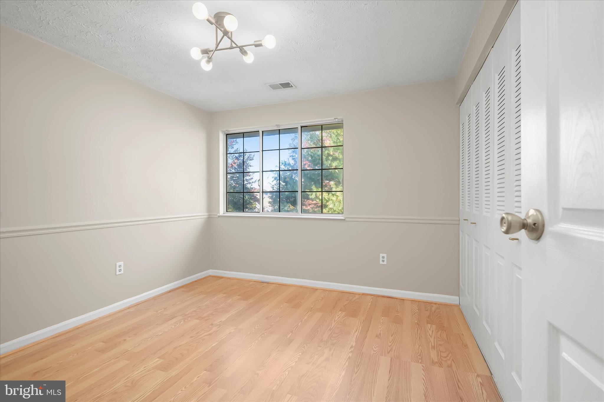 12309 Silvergate Way, Unit 908K Germantown, MD 20874 - Photo 24 of 37 wooden floor in an empty room with a window
