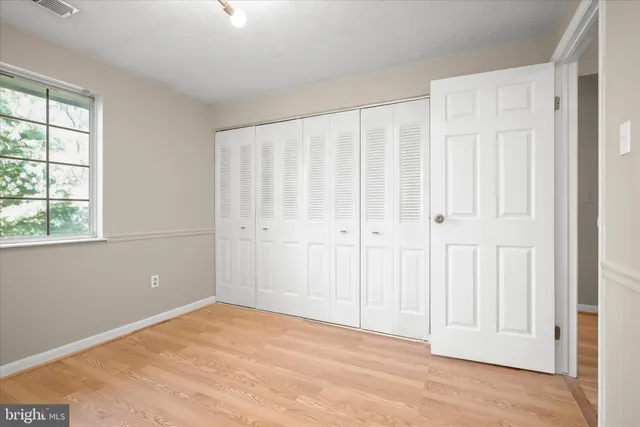 a bathroom with a granite countertop sink a large mirror and a window