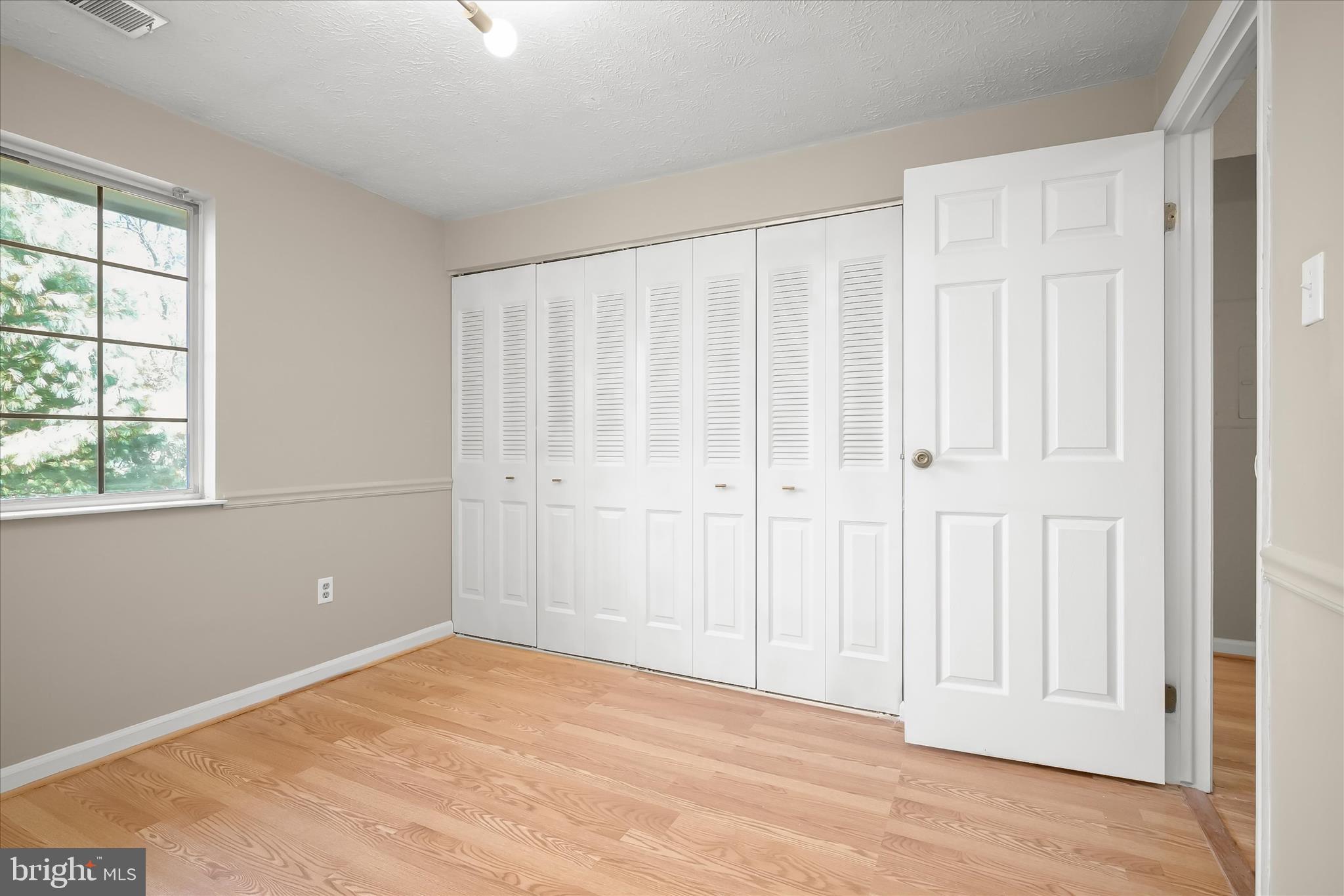 12309 Silvergate Way, Unit 908K Germantown, MD 20874 - Photo 25 of 37 an empty room with wooden floor and windows