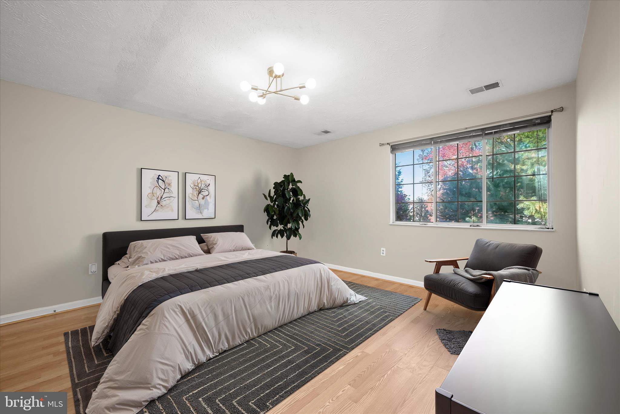 12309 Silvergate Way, Unit 908K Germantown, MD 20874 - Photo 4 of 37 a bedroom with a large bed and a couch