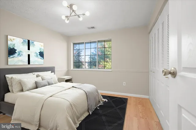 a bedroom with a large bed and a couch