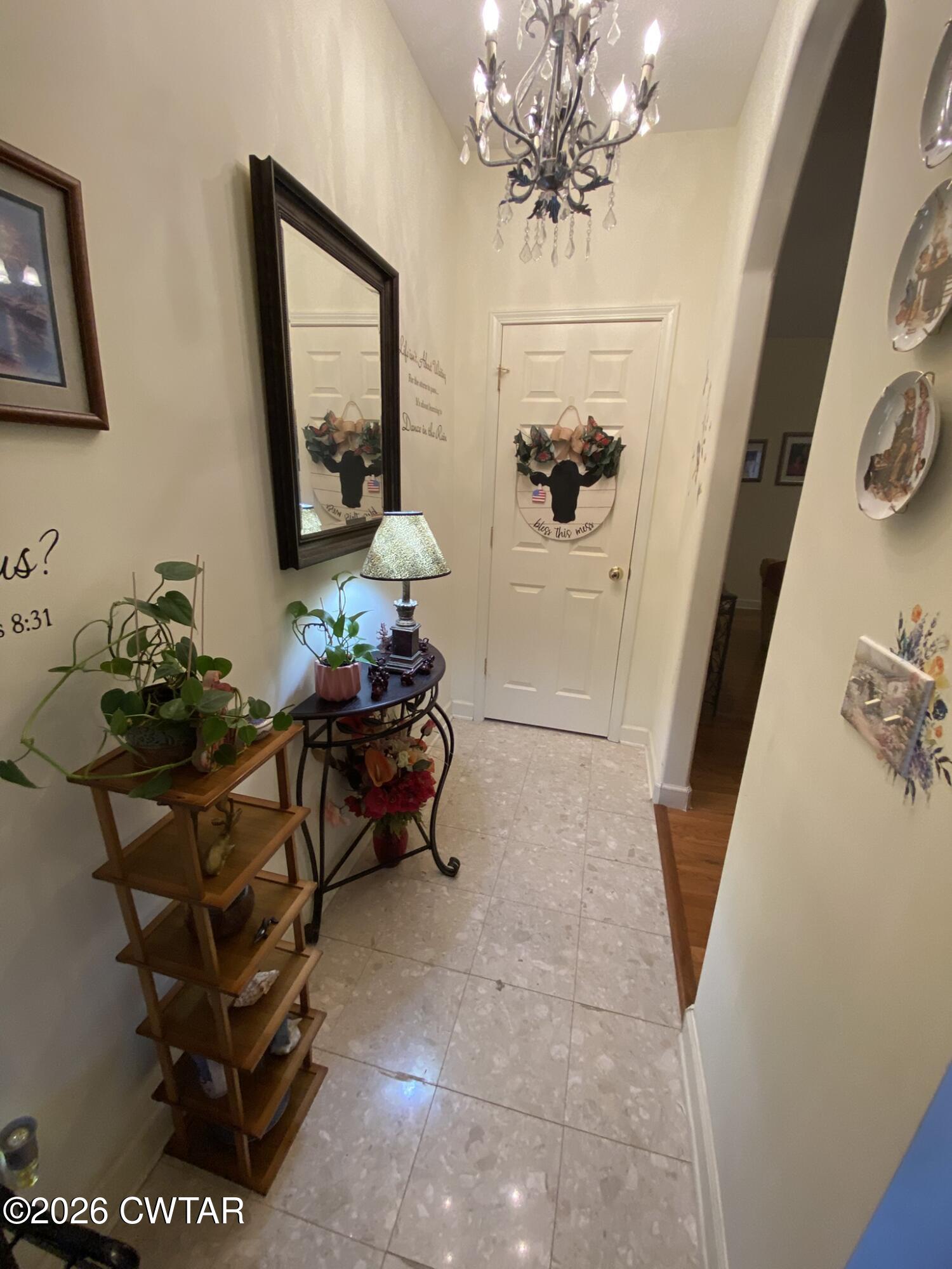 495 Knuckles Road Henderson, TN 38340 - Photo 27 of 80 a living room with furniture and a chandelier