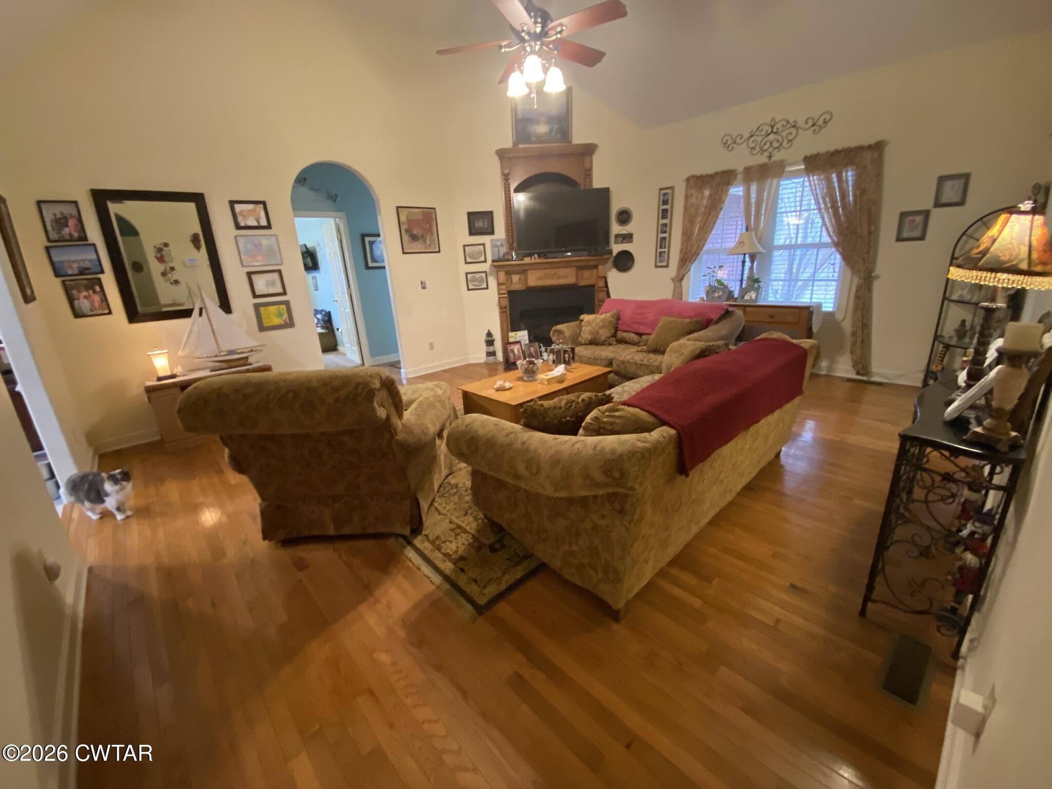 495 Knuckles Road Henderson, TN 38340 - Photo 28 of 80 a living room with furniture a flat screen tv and a fireplace