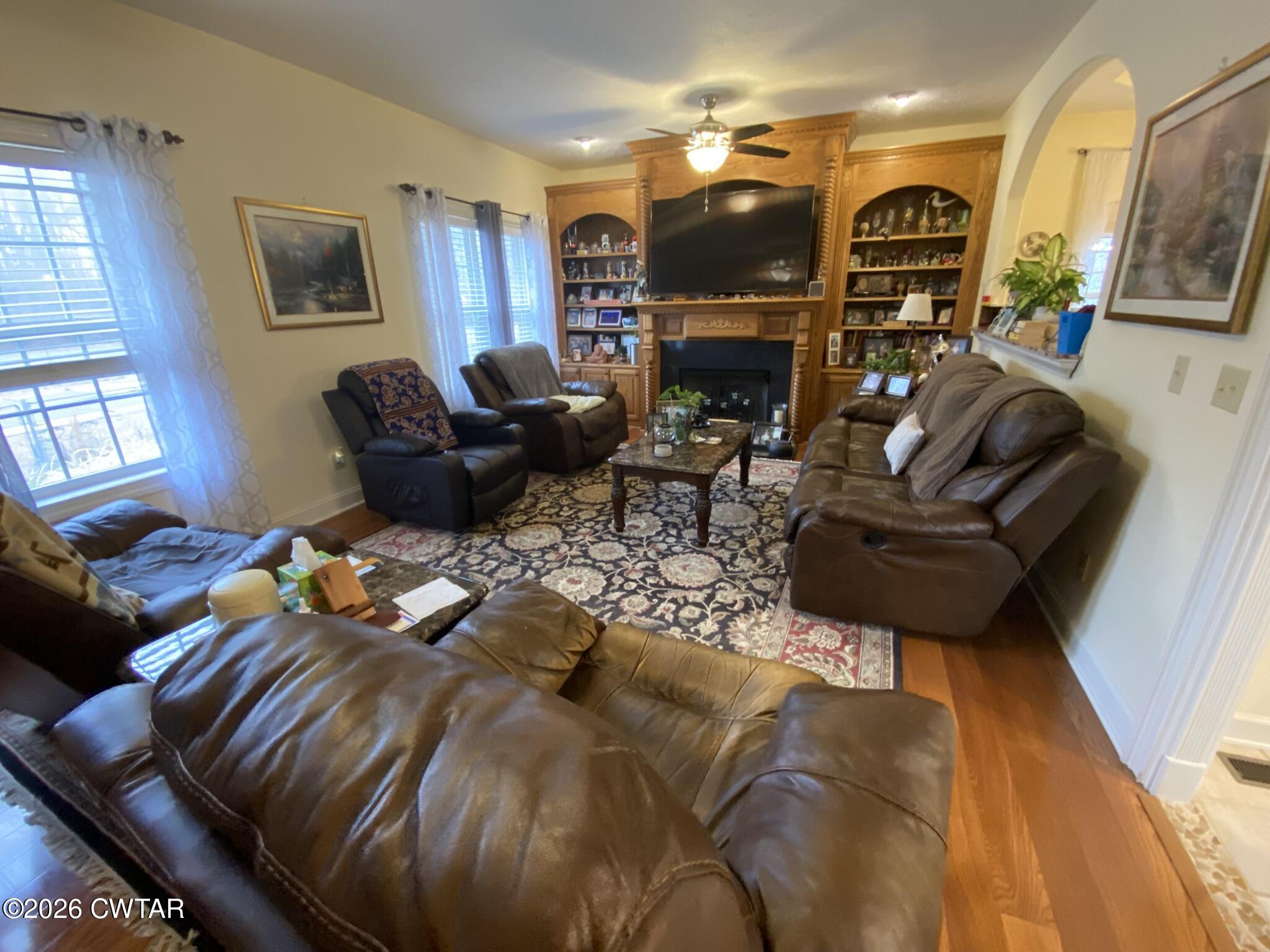 495 Knuckles Road Henderson, TN 38340 - Photo 3 of 80 a living room with furniture a flat screen tv and a fireplace