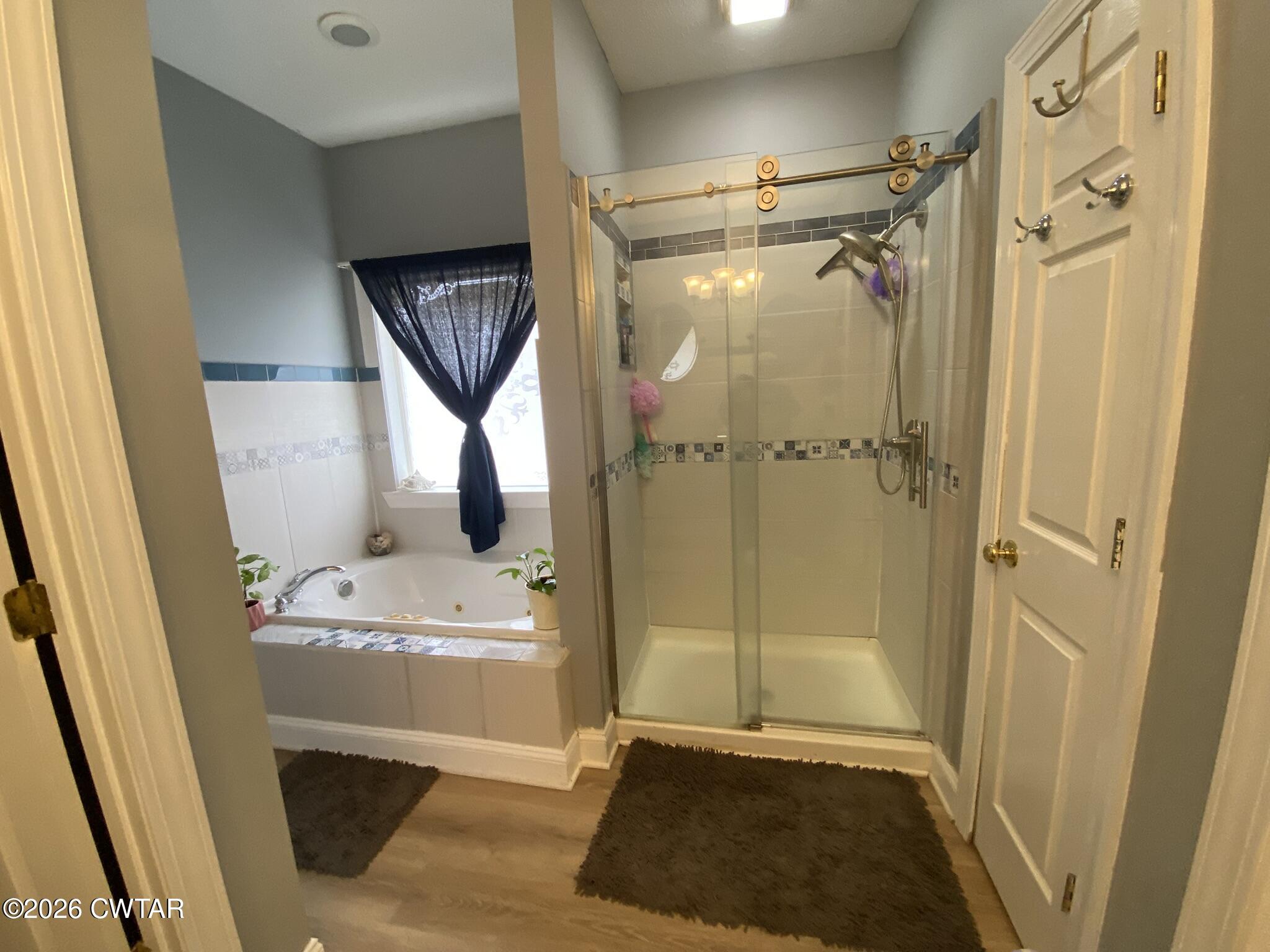 495 Knuckles Road Henderson, TN 38340 - Photo 39 of 80 a bathroom with a tub a sink and a shower