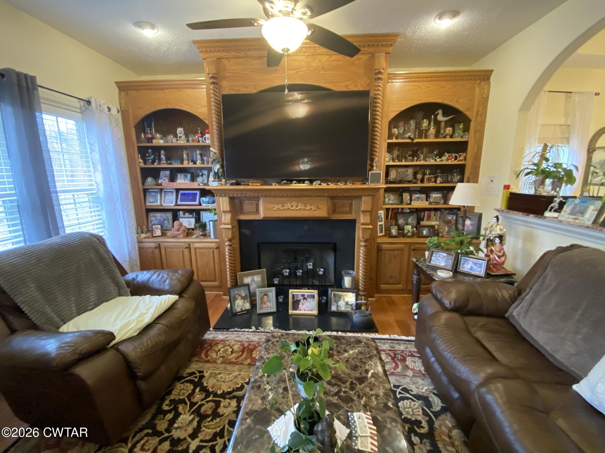 495 Knuckles Road Henderson, TN 38340 - Photo 5 of 80 a living room with furniture a flat screen tv and a fireplace