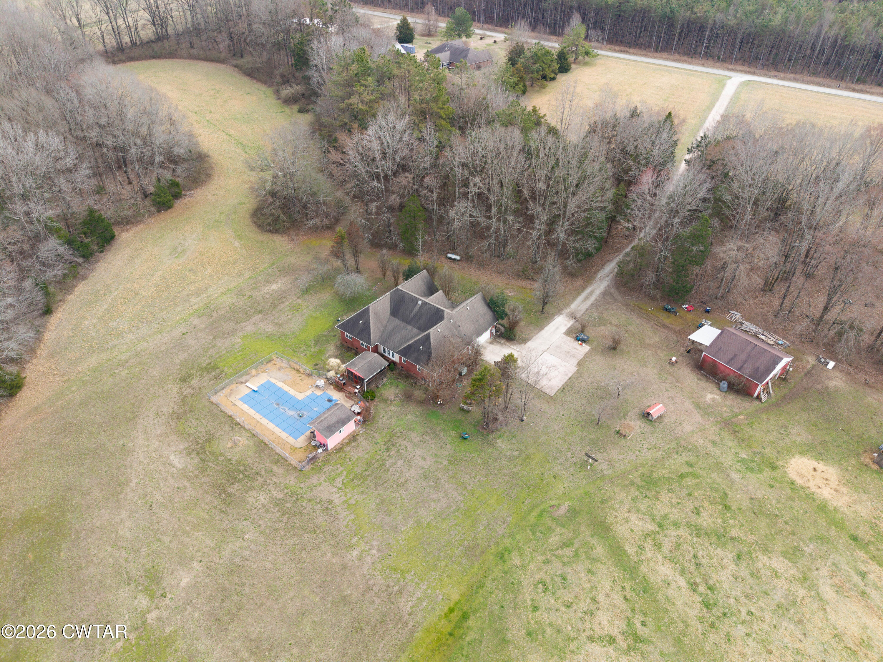 495 Knuckles Road Henderson, TN 38340 - Photo 72 of 80 a backyard of a house with table and chairs