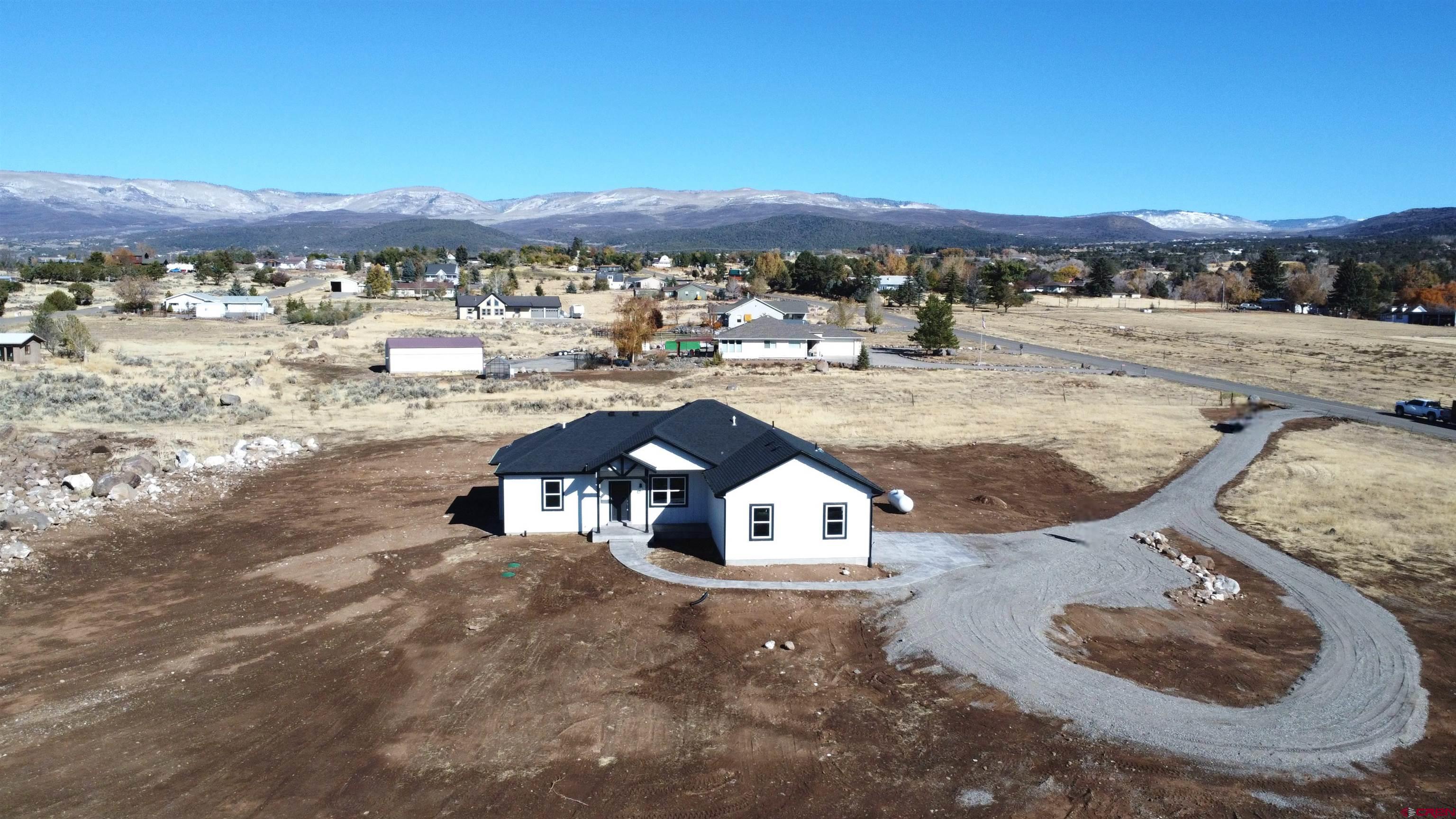 18383 2375 Road Cedaredge, CO 81413 - Photo 16 of 18 a view of a house with a yard and mountain view