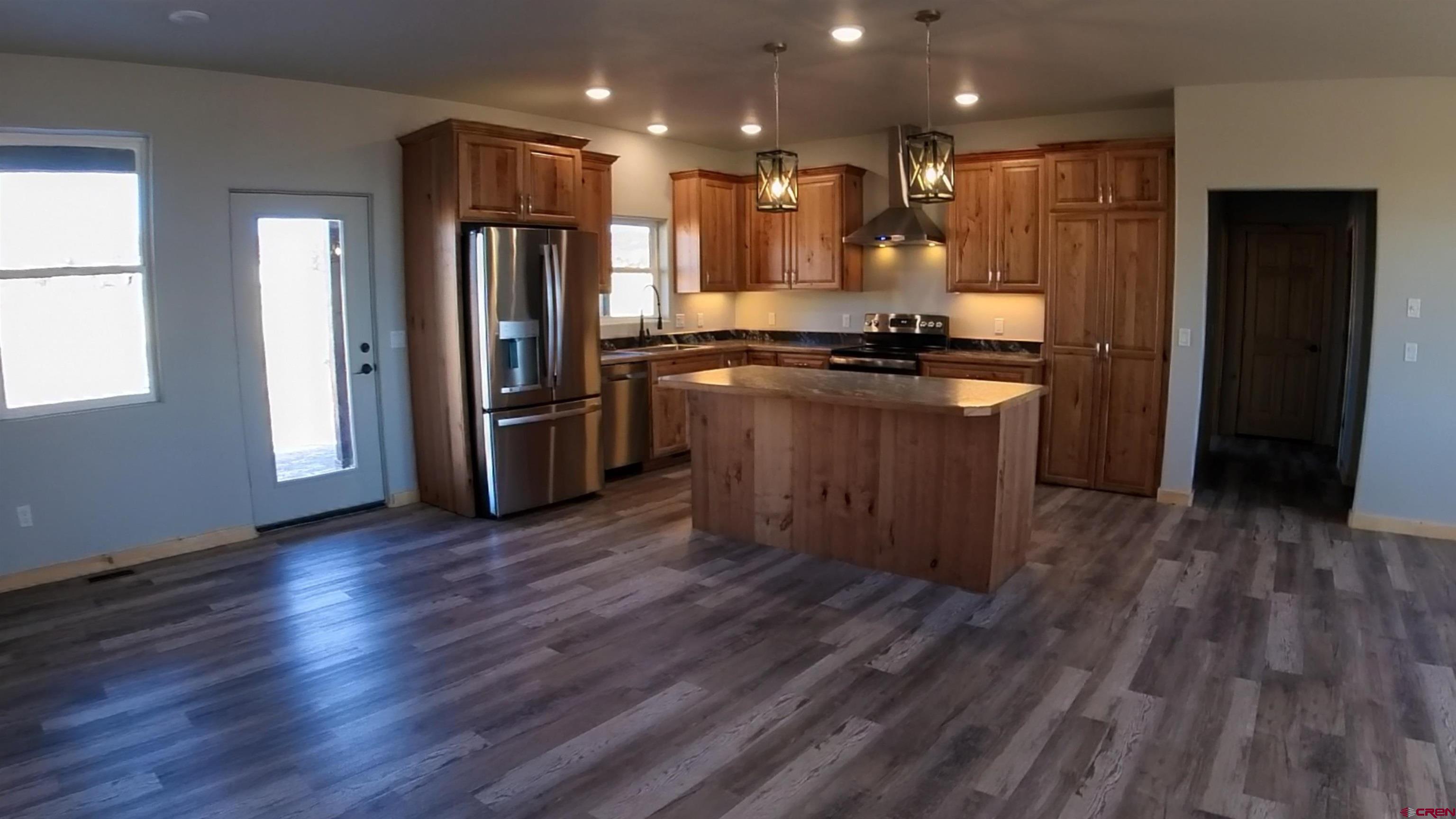 18383 2375 Road Cedaredge, CO 81413 - Photo 2 of 18 a kitchen with stainless steel appliances granite countertop a refrigerator and a stove top oven