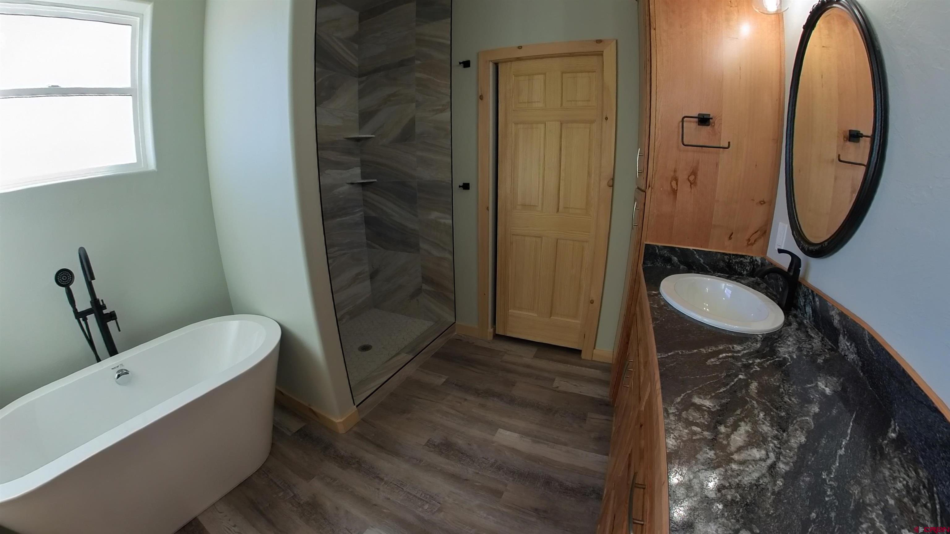 18383 2375 Road Cedaredge, CO 81413 - Photo 5 of 18 a bathroom with a granite countertop sink toilet and shower