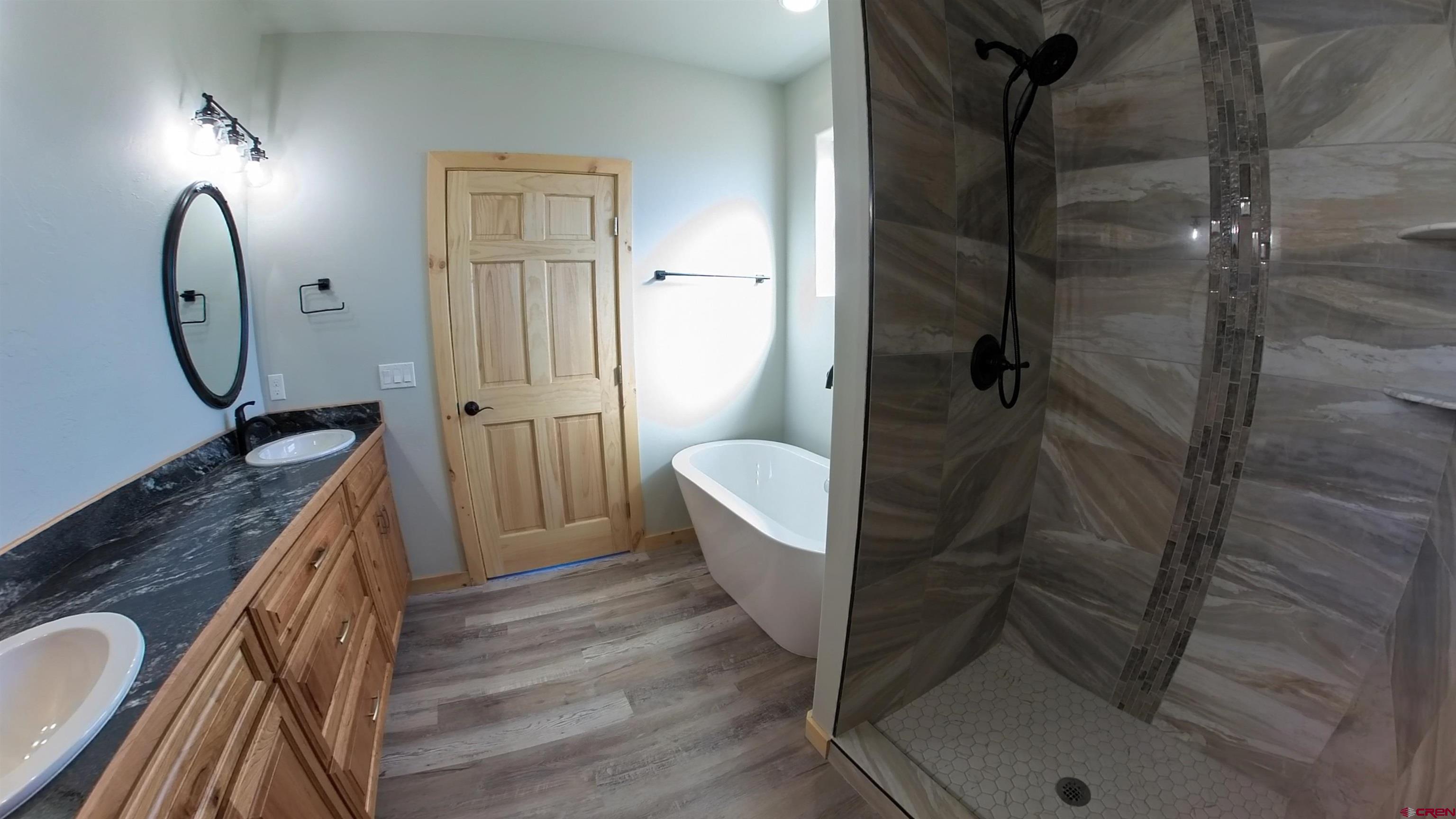 18383 2375 Road Cedaredge, CO 81413 - Photo 8 of 18 a bathroom with a sink a toilet and shower