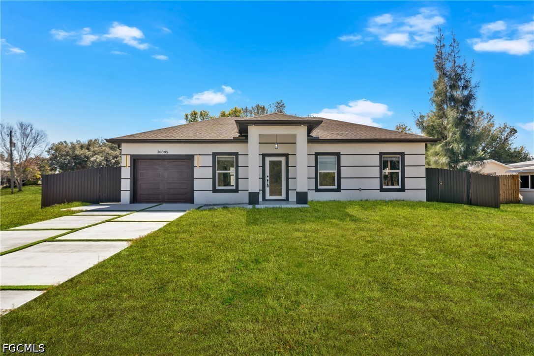a front view of a house with a garden