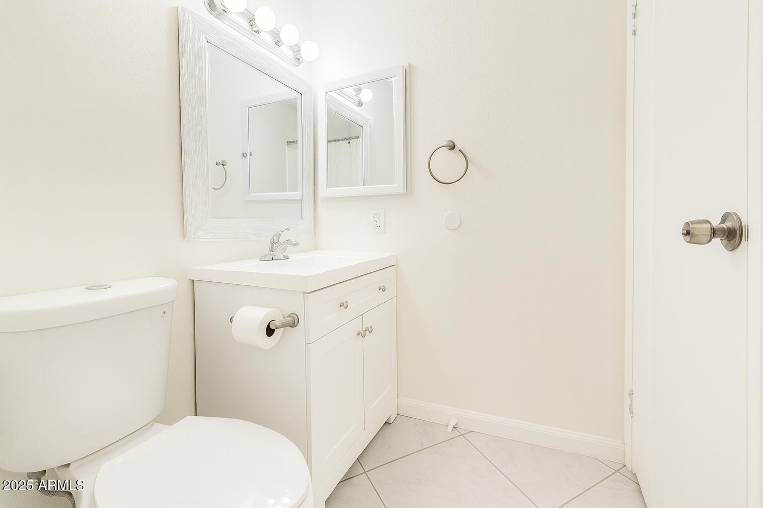 3511 East Baseline Road, Unit 1213 Phoenix, AZ 85042 - Photo 12 of 19 a bathroom with a sink mirror vanity and toilet
