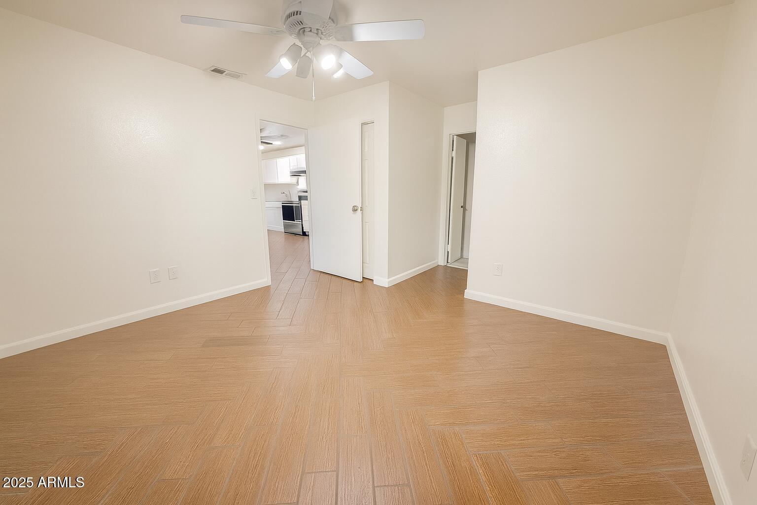 3511 East Baseline Road, Unit 1213 Phoenix, AZ 85042 - Photo 13 of 19 a view of a big room with wooden floor and windows