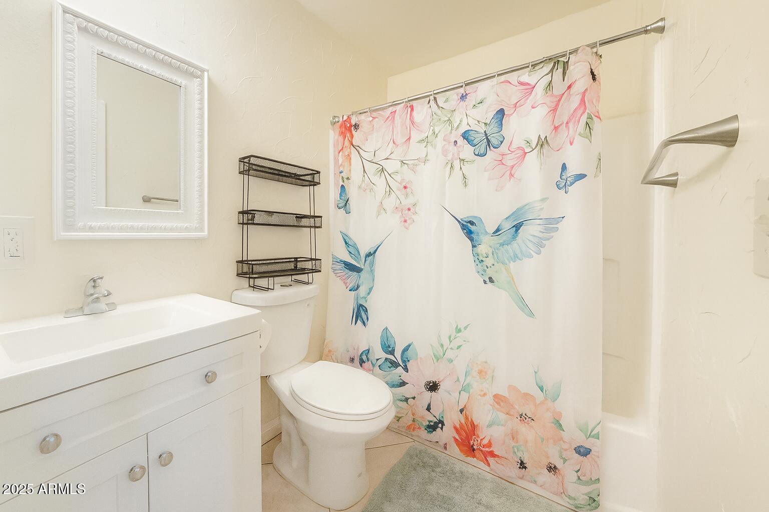 3511 East Baseline Road, Unit 1213 Phoenix, AZ 85042 - Photo 16 of 19 a bathroom with a sink a toilet and a mirror