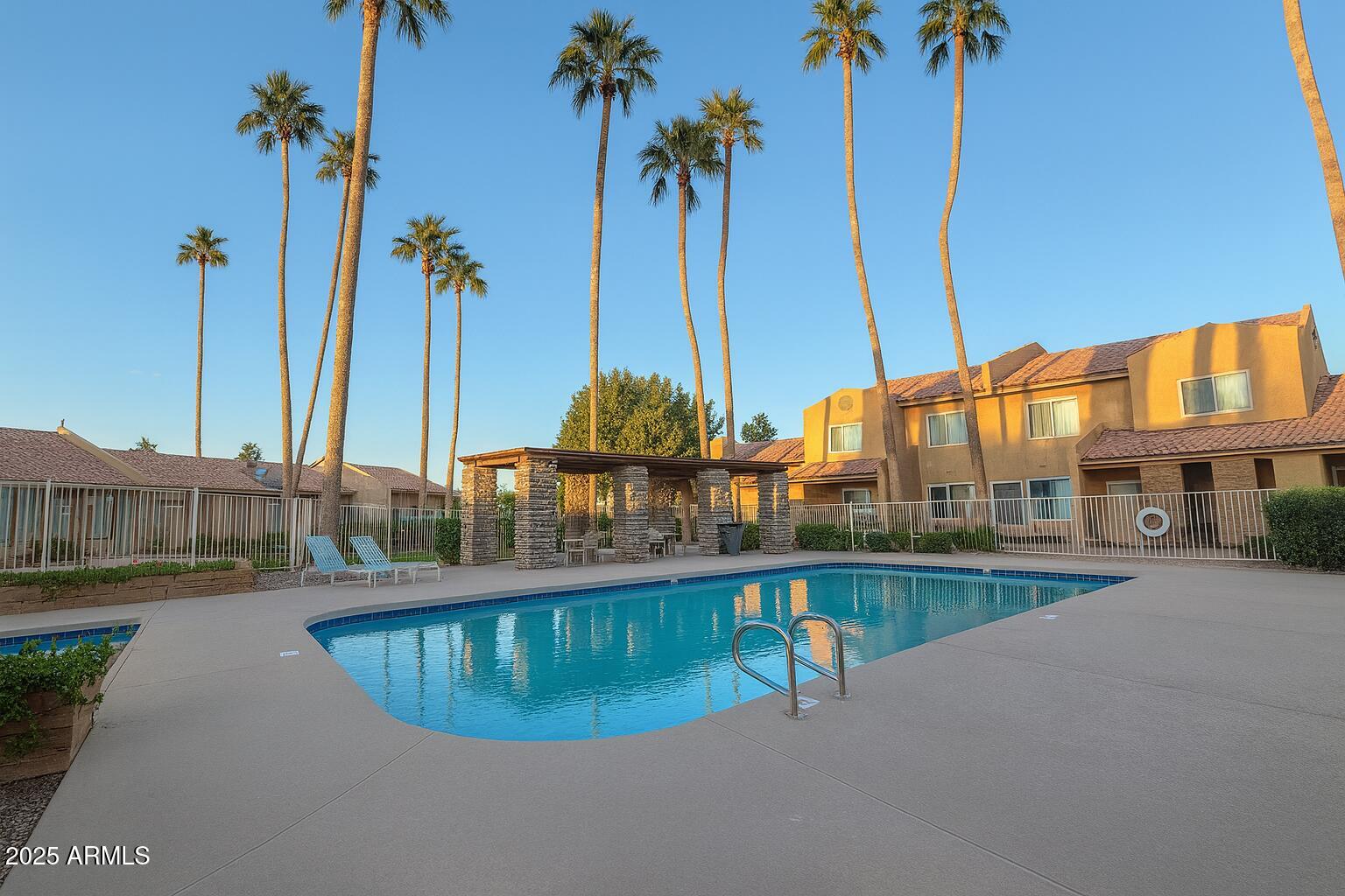 3511 East Baseline Road, Unit 1213 Phoenix, AZ 85042 - Photo 18 of 19 a swimming pool with outdoor seating and yard