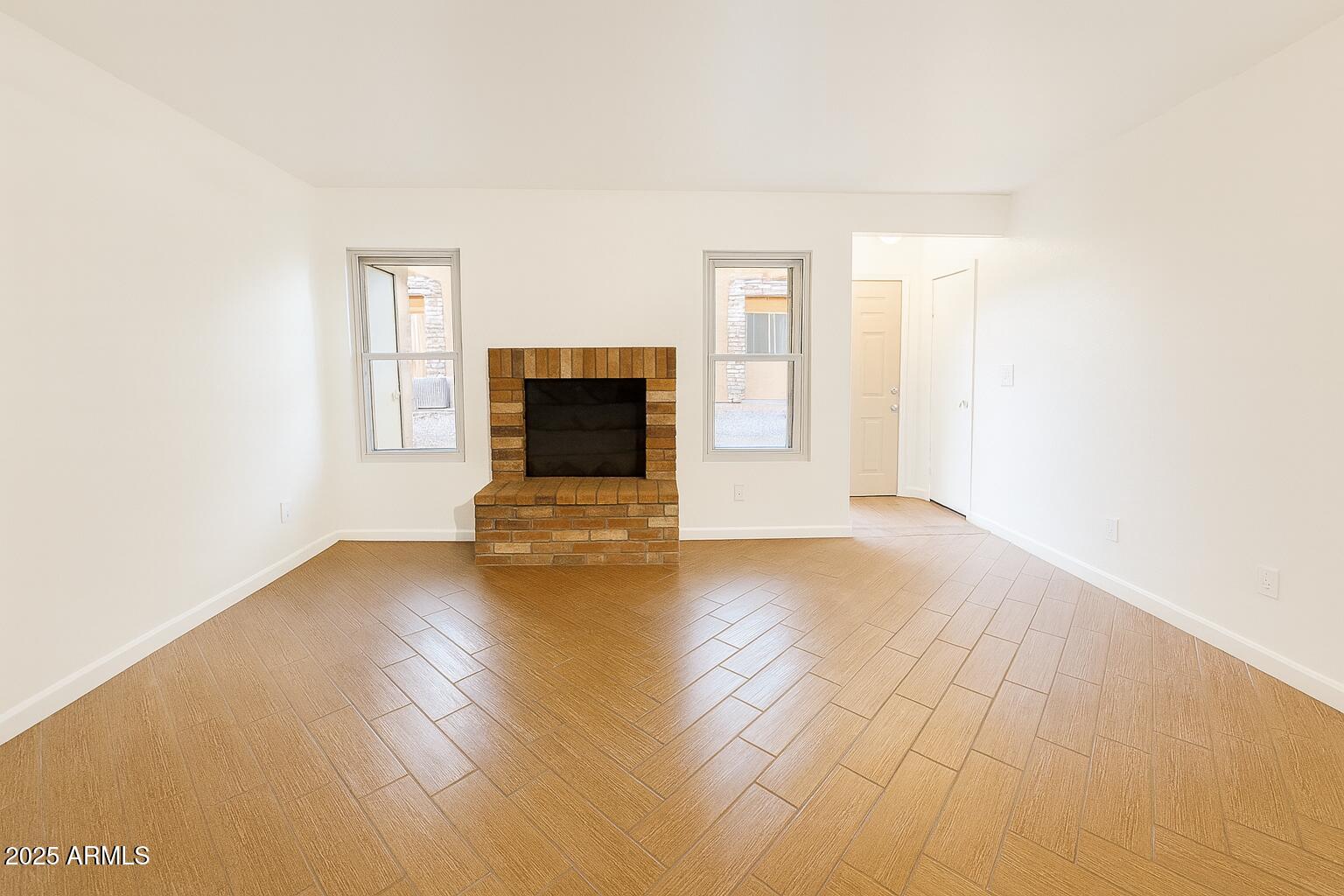 3511 East Baseline Road, Unit 1213 Phoenix, AZ 85042 - Photo 6 of 19 a view of empty room with wooden floor and fan