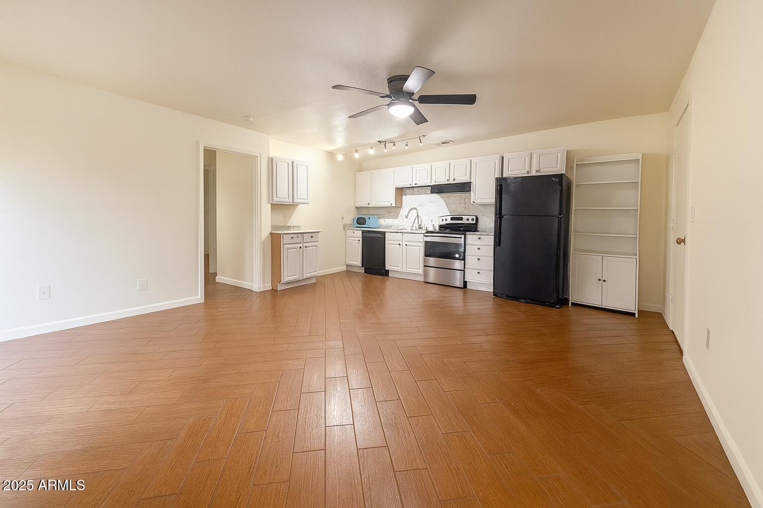 3511 East Baseline Road, Unit 1213 Phoenix, AZ 85042 - Photo 8 of 19 a view of kitchen with refrigerator stove microwave and cabinets