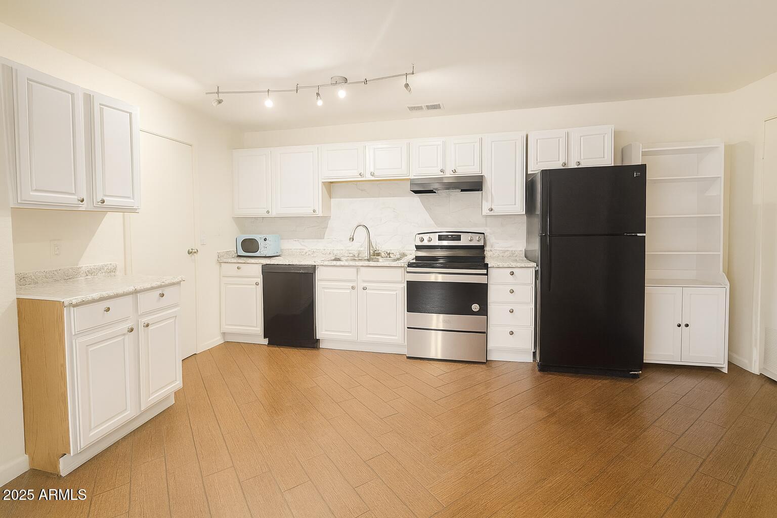 3511 East Baseline Road, Unit 1213 Phoenix, AZ 85042 - Photo 9 of 19 a kitchen with stainless steel appliances a refrigerator a stove a sink and white cabinets
