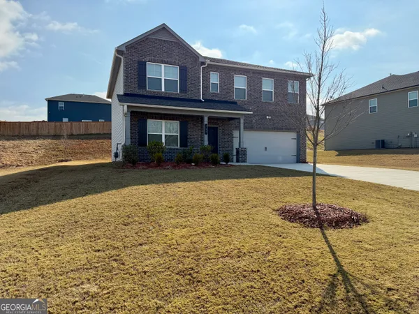 a front view of a house with a yard