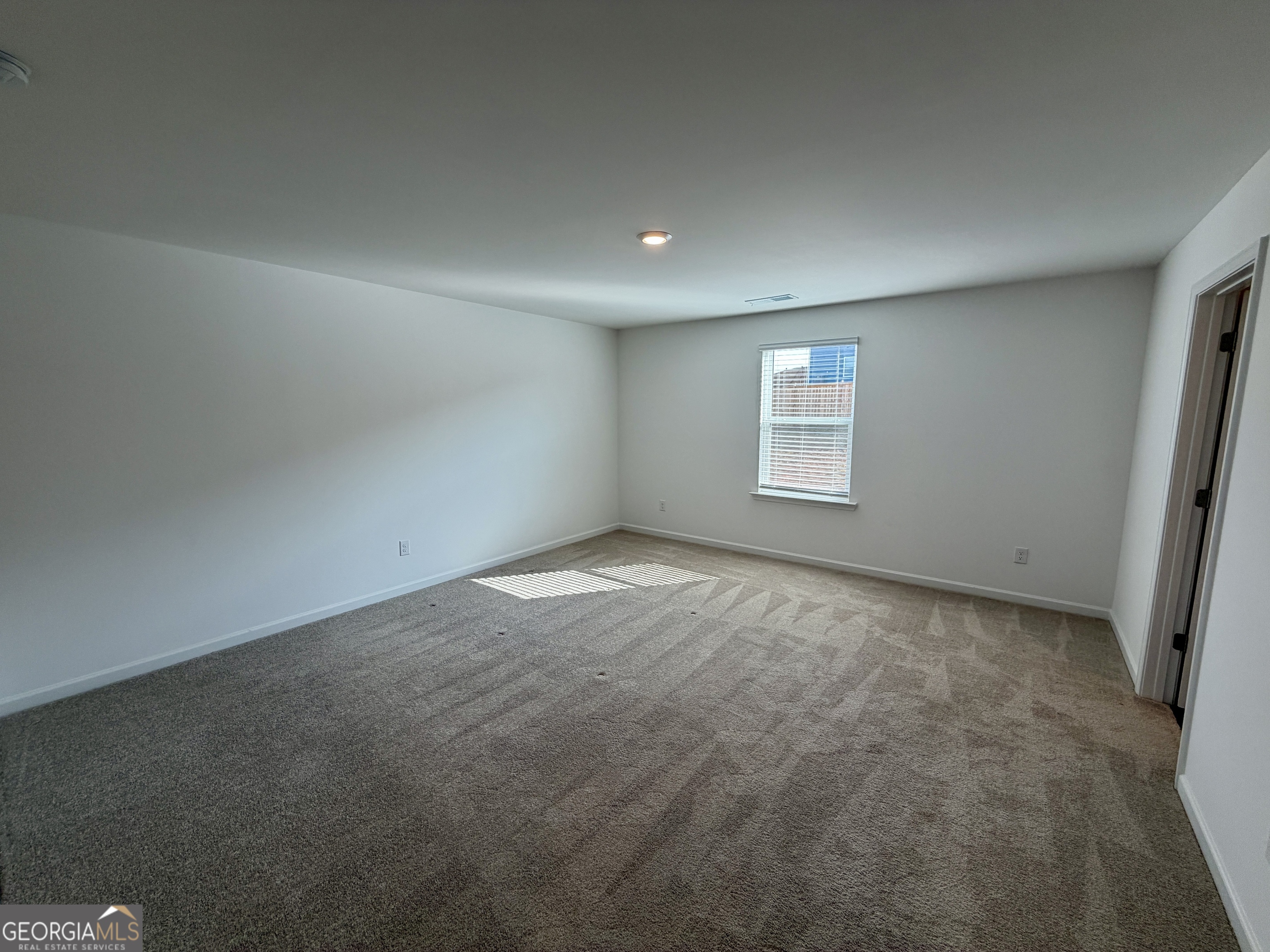 788 Gelderland Drive Hampton, GA 30228 - Photo 15 of 27 an empty room with a window and closet area