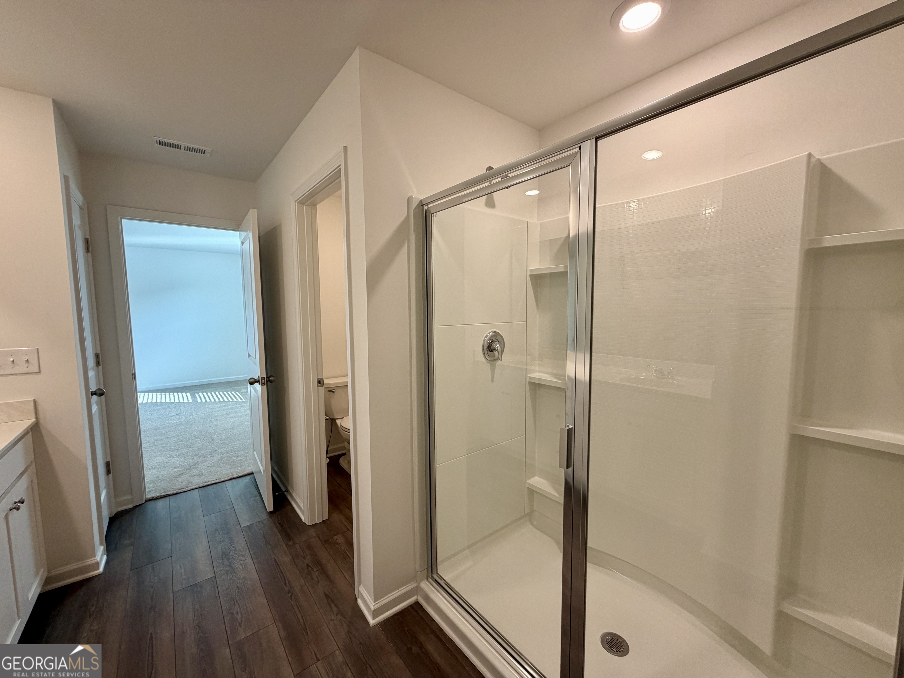 788 Gelderland Drive Hampton, GA 30228 - Photo 18 of 27 a bathroom with a glass shower door