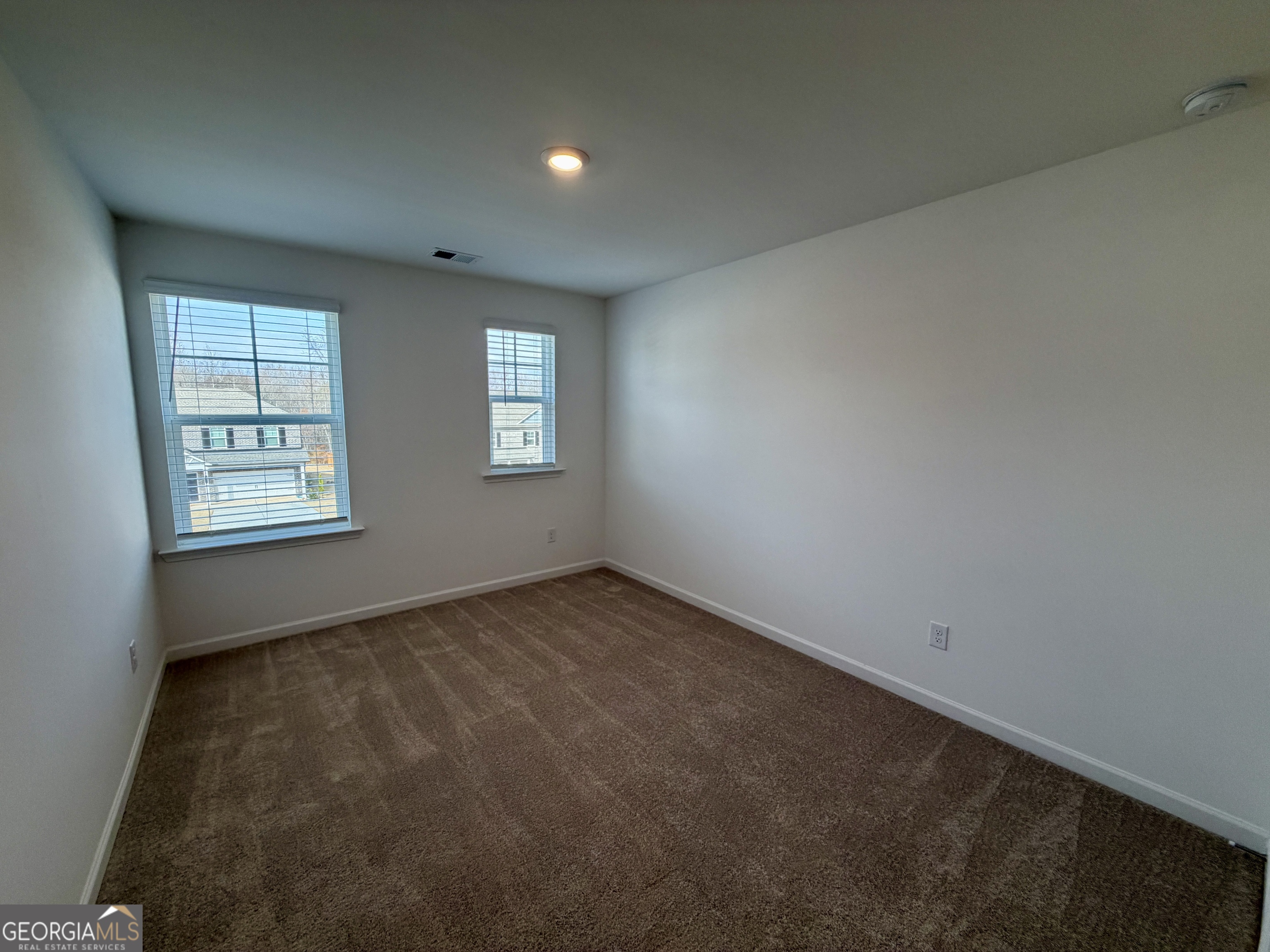 788 Gelderland Drive Hampton, GA 30228 - Photo 21 of 27 an empty room with windows
