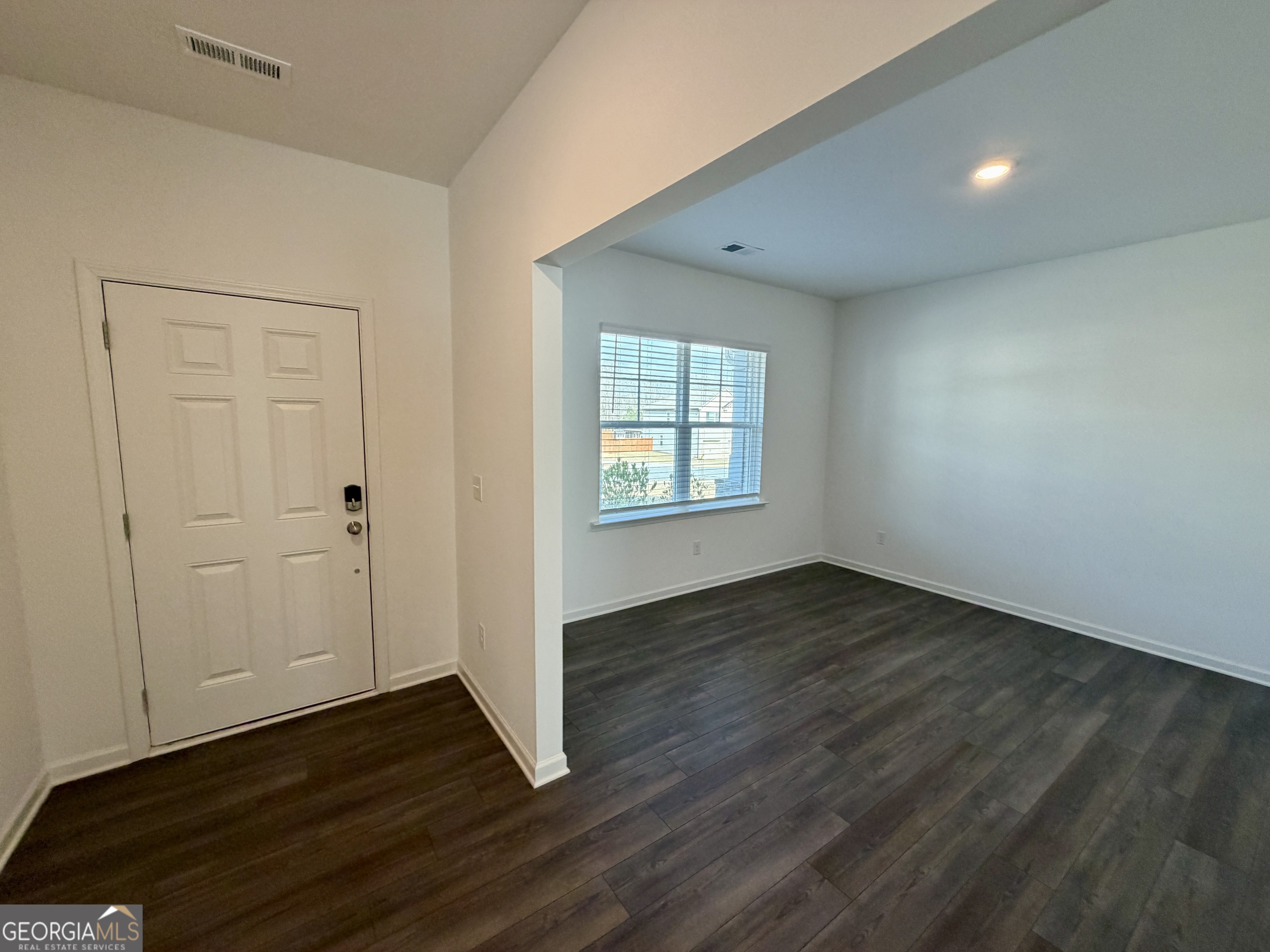 788 Gelderland Drive Hampton, GA 30228 - Photo 3 of 27 an empty room with wooden floor and windows