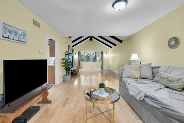 a spacious bathroom with a double vanity sink a mirror and shower