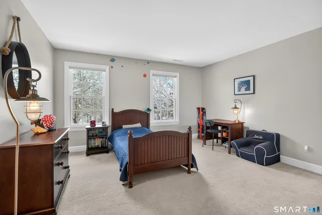 a living room with furniture a window and gym equipment