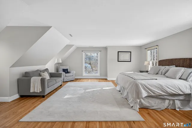 a spacious bedroom with a large bed and a couch