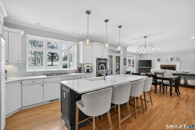 a large kitchen with a table and chairs
