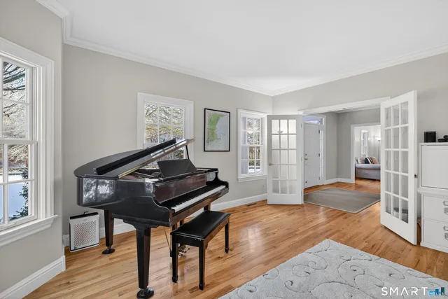 a living room with furniture and a piano