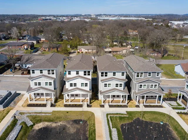 an aerial view of a residential apartment building with a lake view