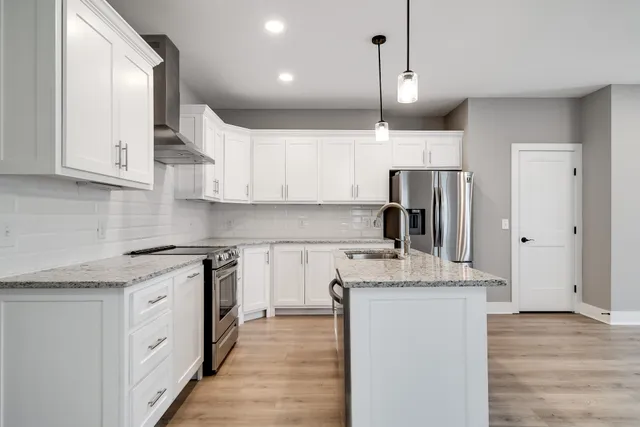 a kitchen with a sink stove and refrigerator